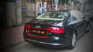Why do four-wheeler have Black Number plate in India