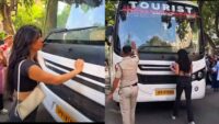Delhi Protest another young woman blocks police vehicle